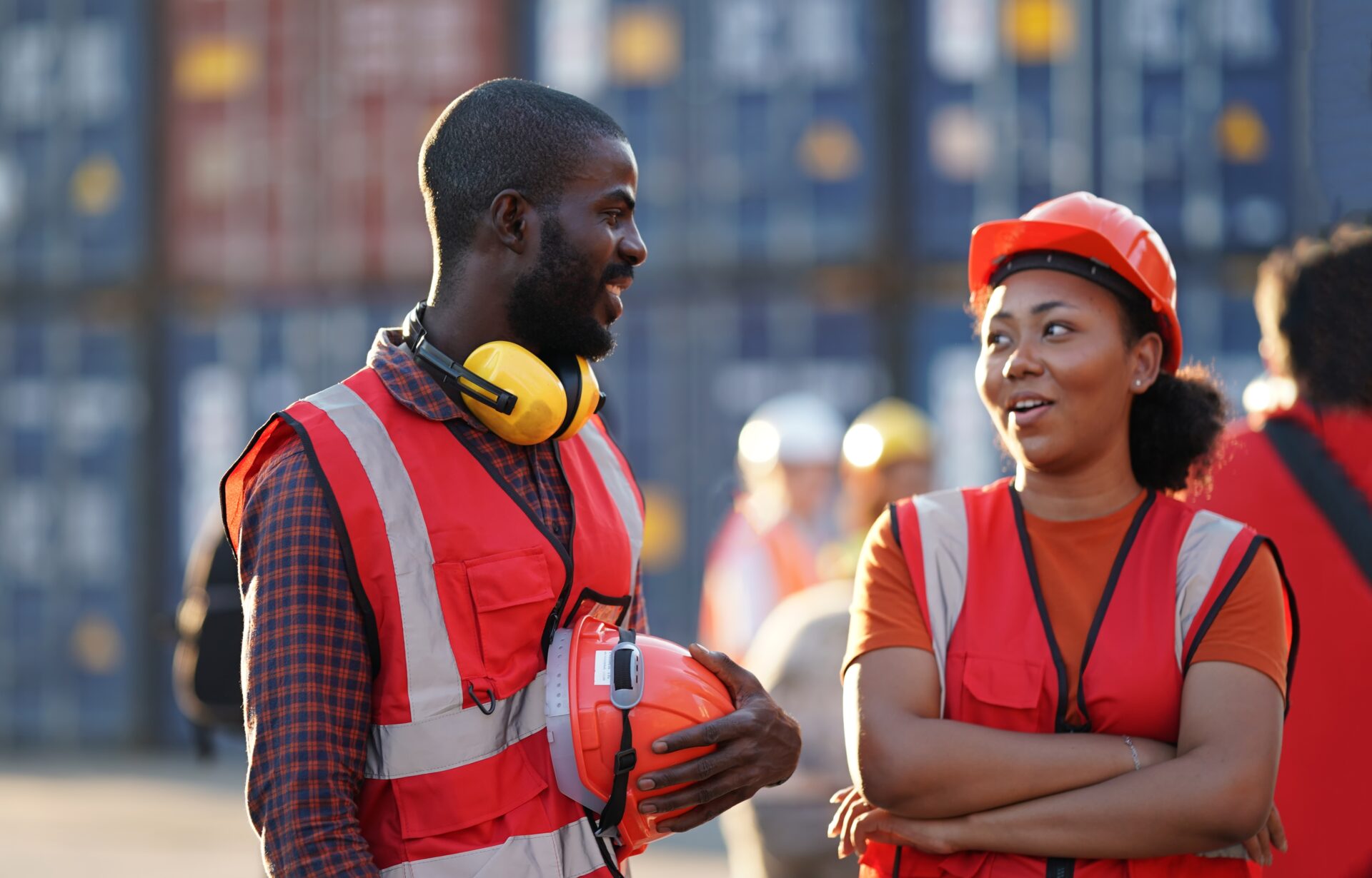 two workers in uniform on a construction site